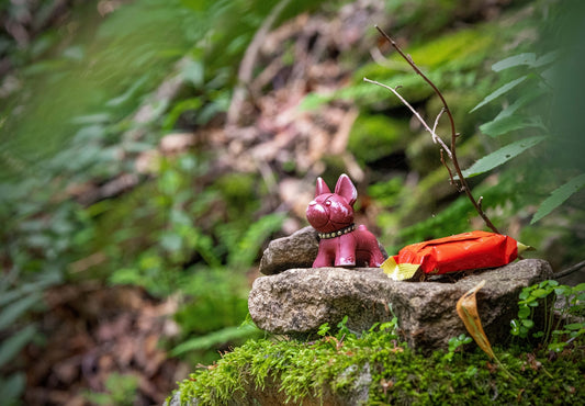 a toy figurine on a rock