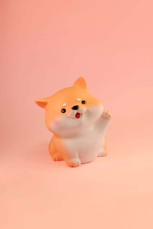 a small figurine of a dog on a pink background